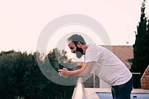 Young man using a chat app in his forest house