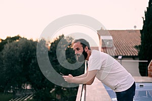 Young man using a chat app in his forest house