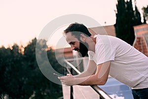 Young man using a chat app in his forest house