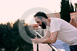 Young man using a chat app in his forest house