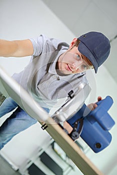 Young man using circular saw