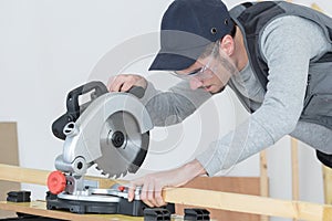 Young man using circular saw