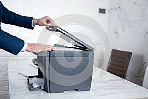Young man using a copy machine