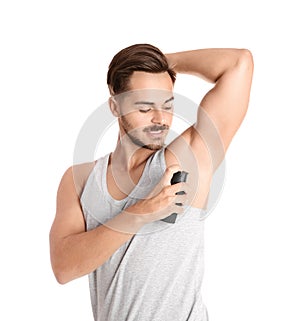 Young man using deodorant