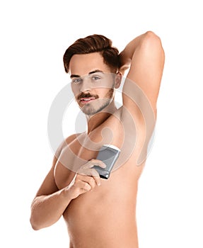 Young man using deodorant