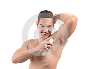 Young man using deodorant on white background