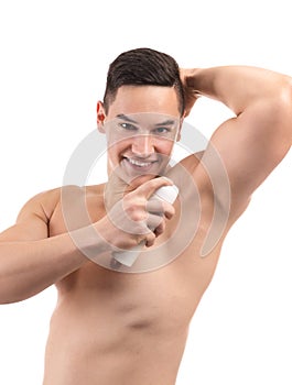 Young man using deodorant on white background