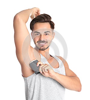 Young man using deodorant