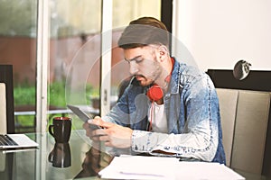 Young man using digital tablet.