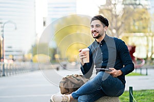 Young man using digital tablet outdoors.