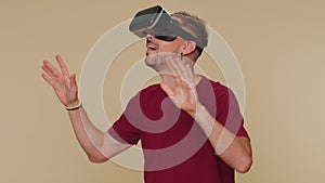 Young man using headset helmet app to play simulation drawing game watching virtual reality 3D video