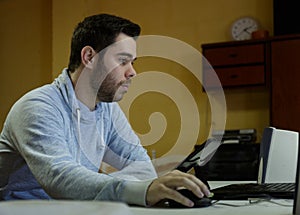 Young man using his mobile, tablet, laptop and headphones