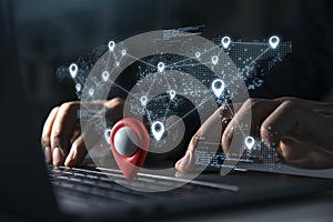 Young man using laptop with Blue markers with user icons on the map