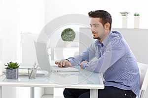 Young man using laptop computer