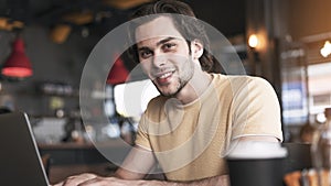 Young man using laptop computer in cafe
