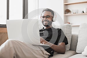 Young man using laptop computer at home, Student men resting in his room, working at home concept