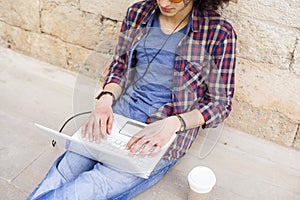 Young man using laptop and headphones