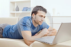 Young man using laptop at home