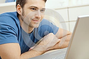 Young man using laptop at home