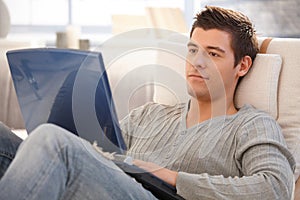 Young man using laptop at home