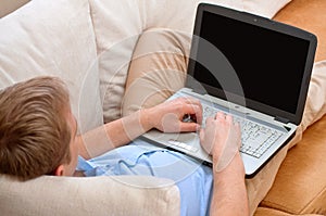 Young man using a laptop at home