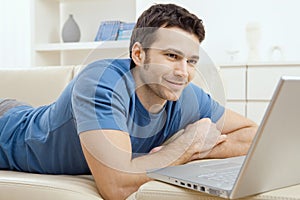 Young man using laptop at home