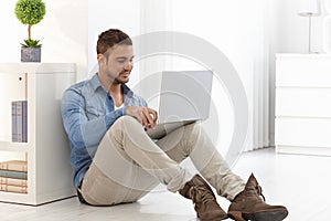 Young man using laptop at home