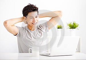 young man using laptop in living room