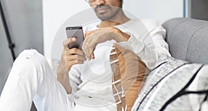 Young man using mobile phone at home, connection and communication