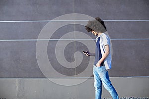 Young man using mobile phone on street