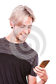 Young man using mobile phone texting on smartphone