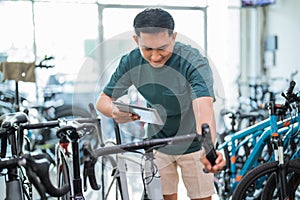 young man using a pad while trying out a bicycle grip handle