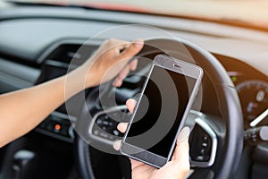 Young  man using phone while driving the car