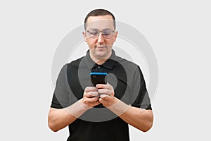 Young man using a phone, isolated on a light gray background