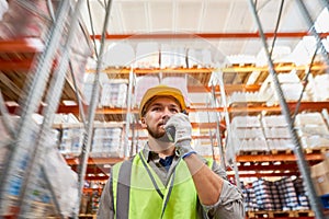 Young Man Using Radio in Warehouse