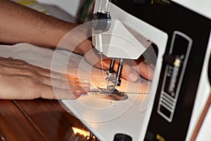 Young man using a sewing machine