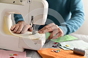 Young man using a sewing machine
