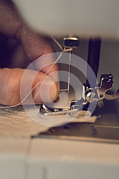 Young man using a sewing machine