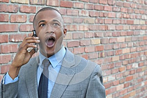 Young man using smart phone getting shocking news. Surprised businessman calling with mobile smartphone