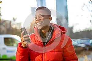 Young man using smart phone outdoors at urban setting