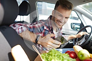 Young Man Using Smartphone in Car