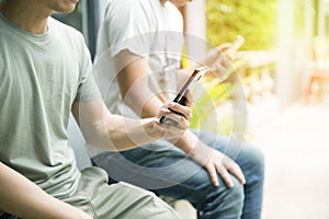 Young man using smartphone chatting with their mobilephone searching or social networks concept