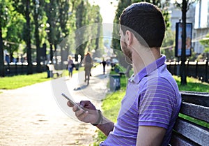 Young man using smartphone outdoors