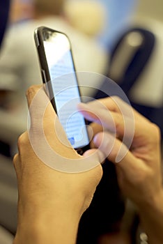 Young man using a smartphone in a train or a subway