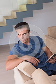 Young man using a tablet at home