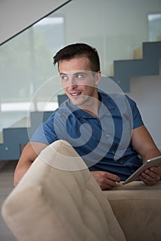 Young man using a tablet at home