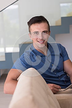Young man using a tablet at home