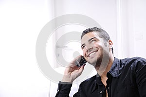 Young man using telephone