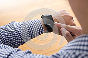 Young man Using Touchscreen Smart Watch