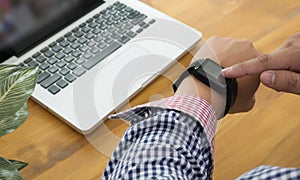 Young man Using Touchscreen Smart Watch